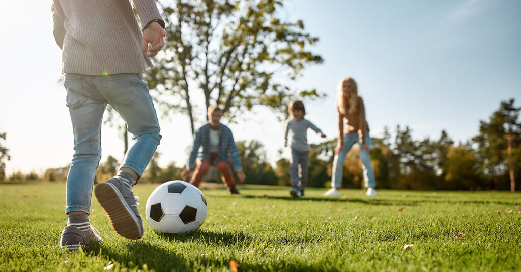 Four pillars of online sales - four children playing soccer in park