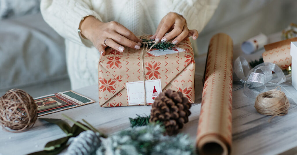Holiday grey market tech sales - woman wrapping a holiday gift