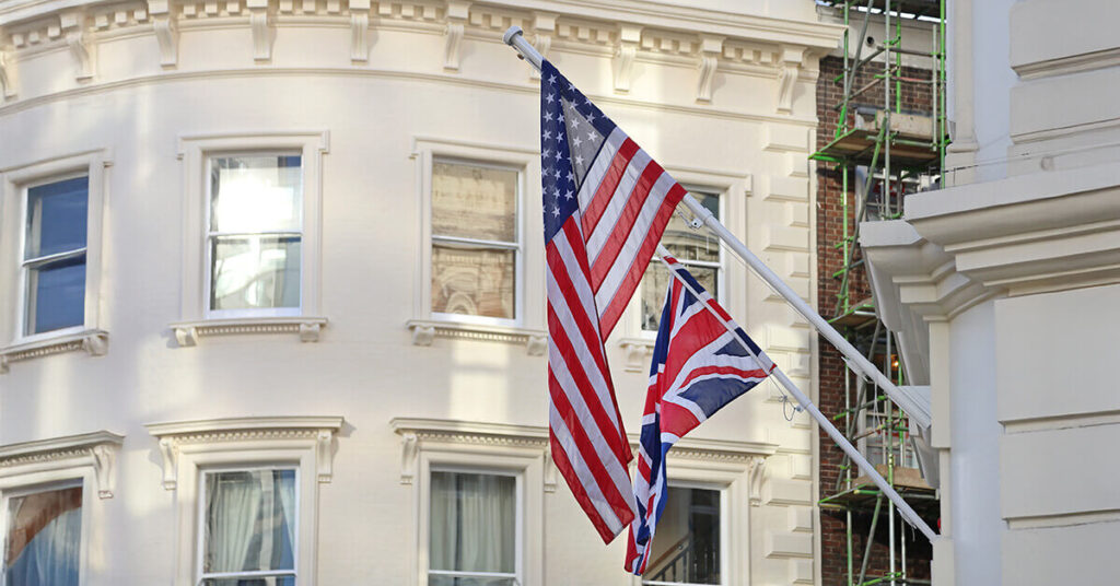Control online sales in Europe and US - US and UK flags flying from the side of a large building